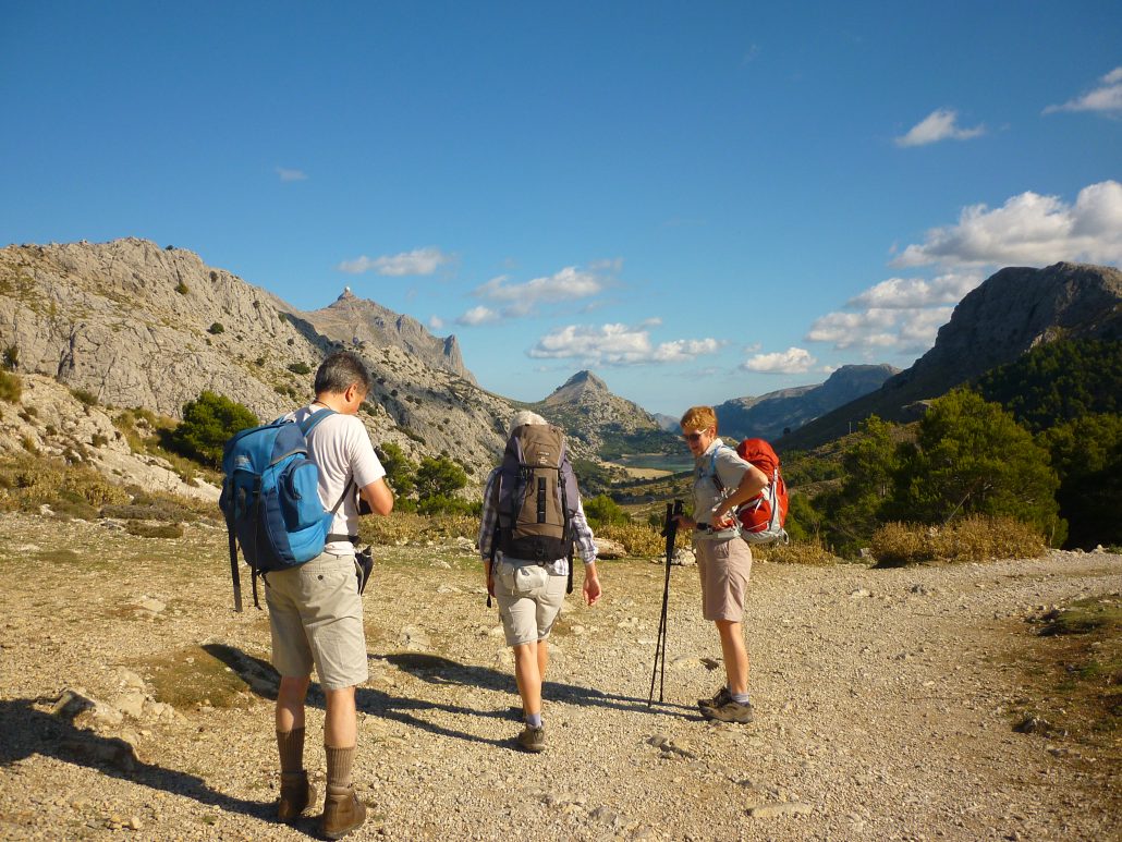 Image shows walkers trekking in the heat on a hot day taking a rest to prevent exhaustion
